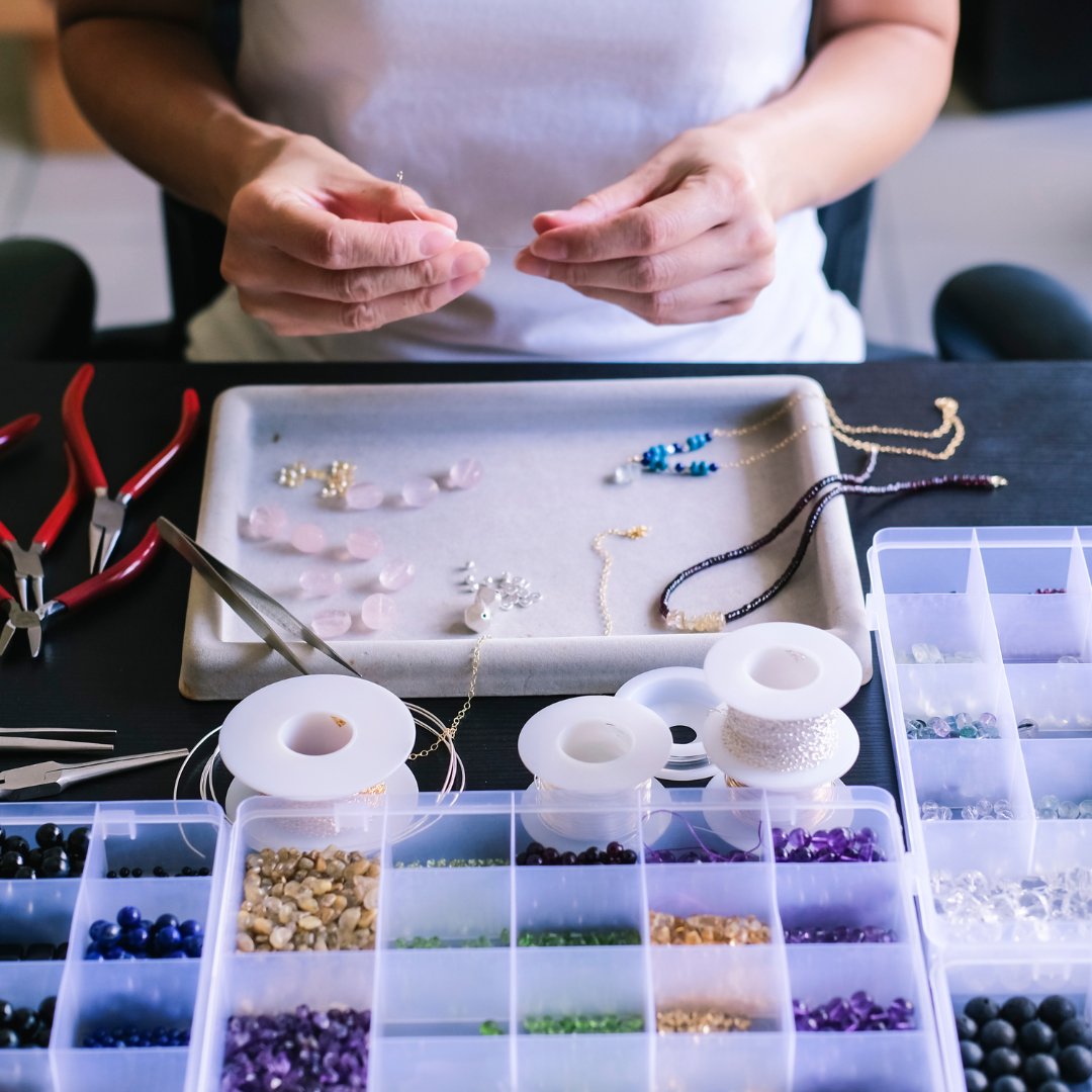 student making jewelry with wire and beads | The Eclectic Chic Boutique