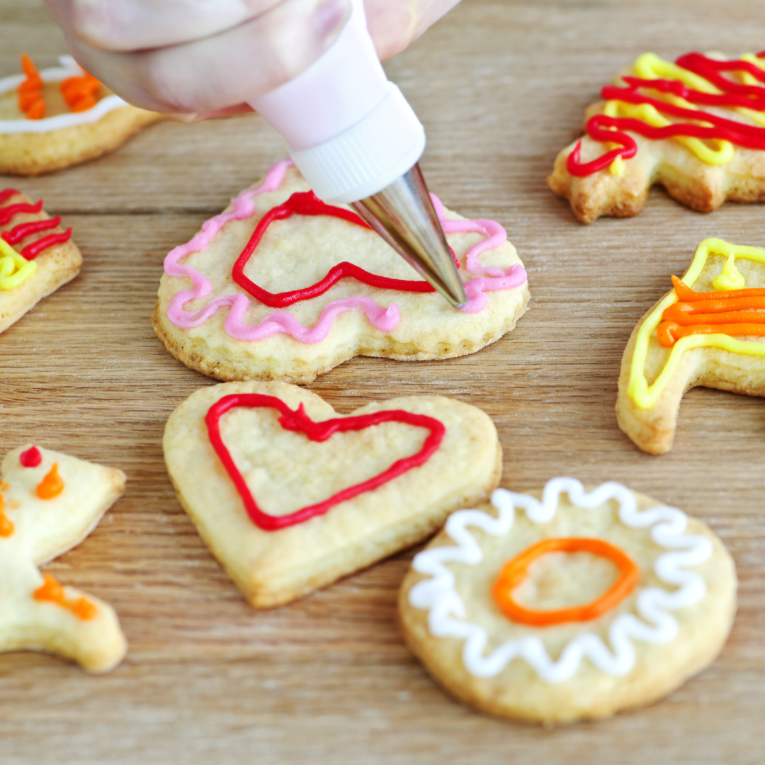 Student decorating cookies with piping icing | The Eclectic Chic Boutique