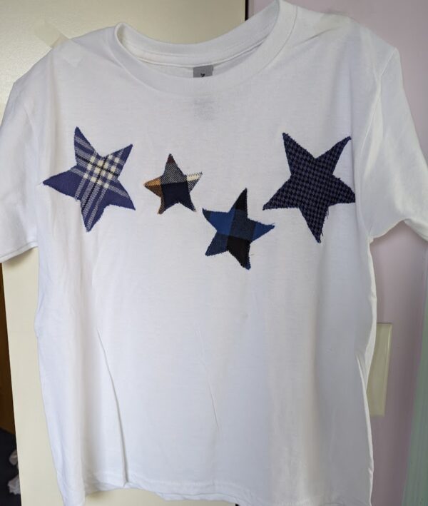 White t-shirt with four blue stars