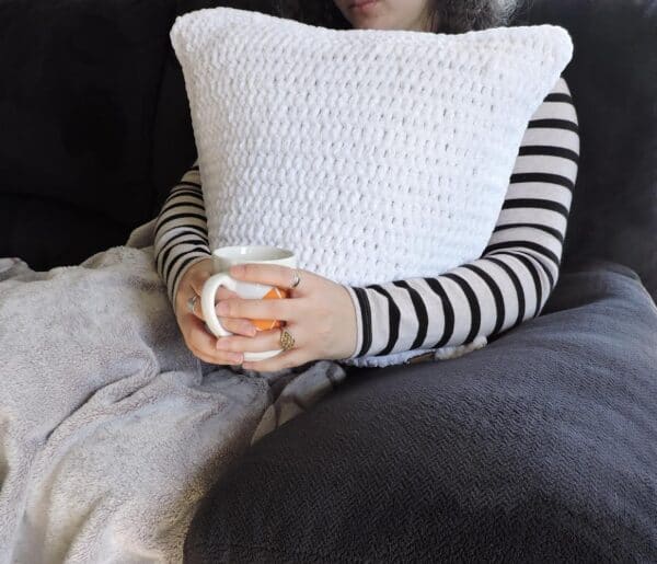 White Velvet Crochet Pillow on Couch