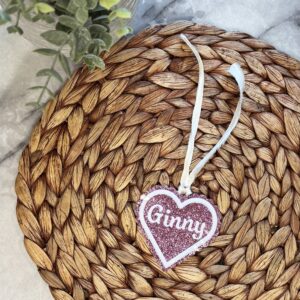 Three inch pink acrylic heart with scalloped edge. Outlined with a white heart. Center of heart contains name in white acrylic.